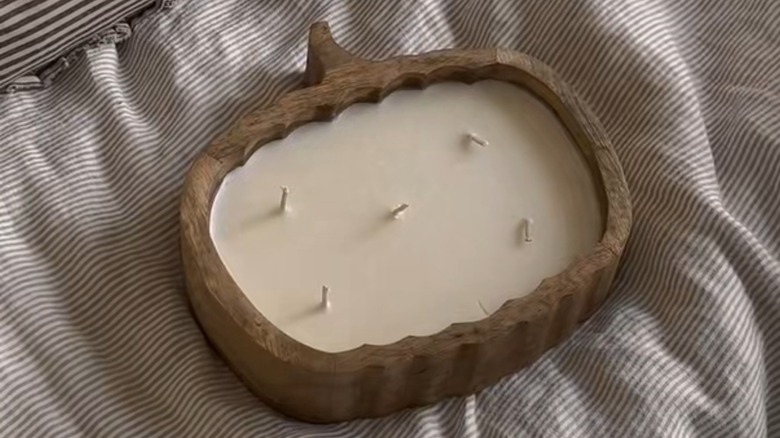 Wood pumpkin candle from Aldi on a blanket
