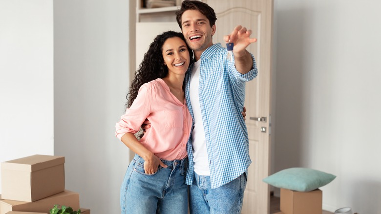 couple smiling with house key 