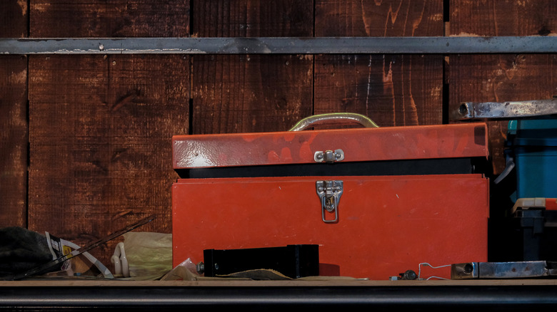 red metal toolbox on bench