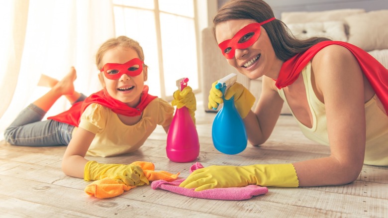 Woman and girl cleaning floor