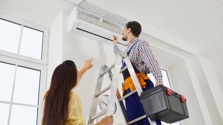 Person repairing AC