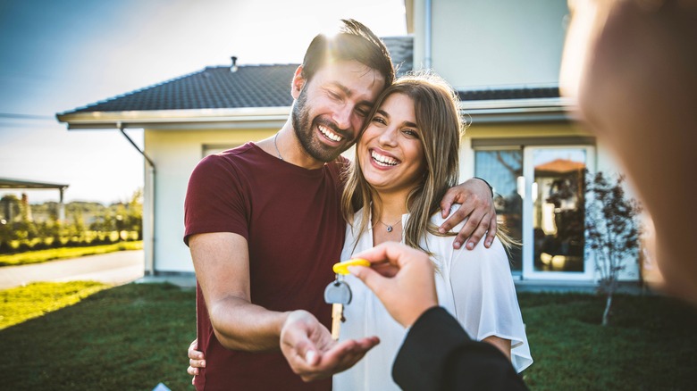 Couple receiving home key