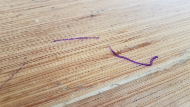 Marker pen stains on wood surface