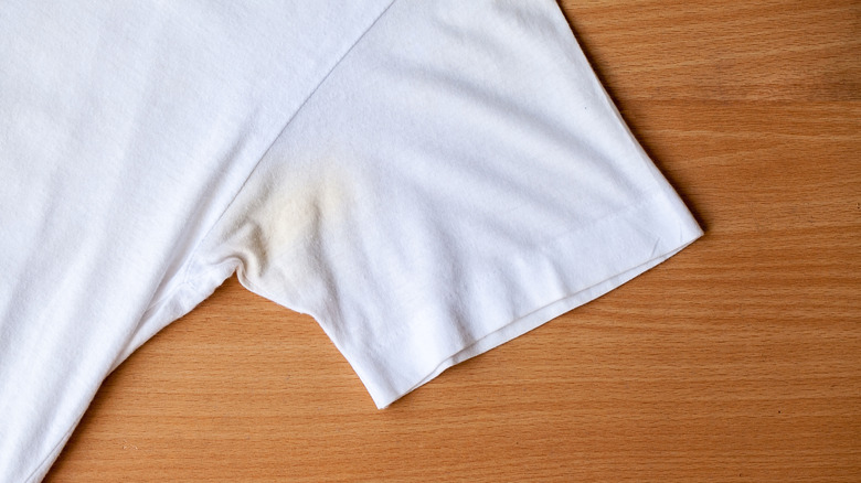 Yellow sweat stain near armpit of a white shirt