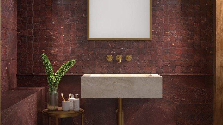 A bathroom covered in red marble tile