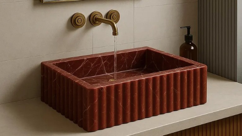 A modern red marble vessel sink.