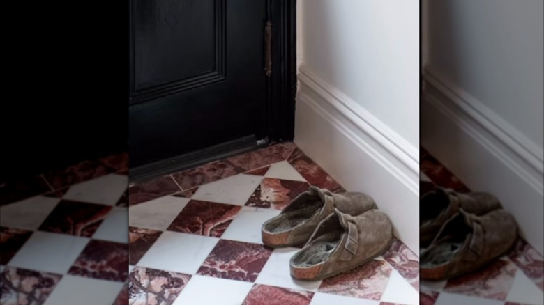small red and white marble checkerboard tiles on entryway floor