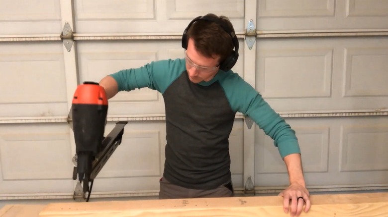 Man using a framing nail gun