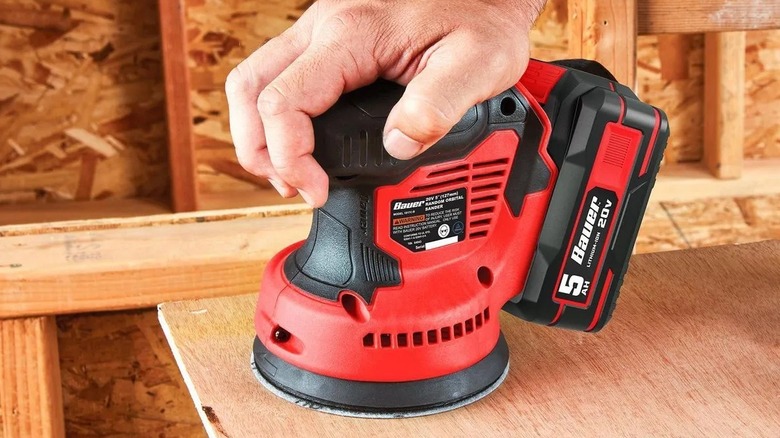 Person using an orbital sander