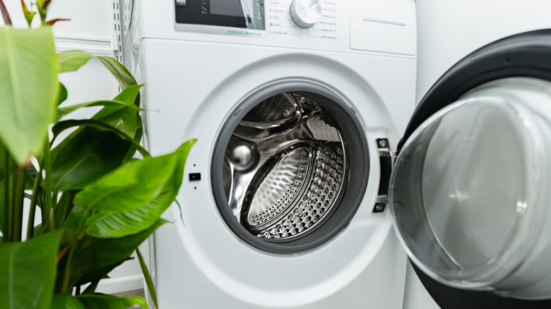 The washing machine door is left open to dry it