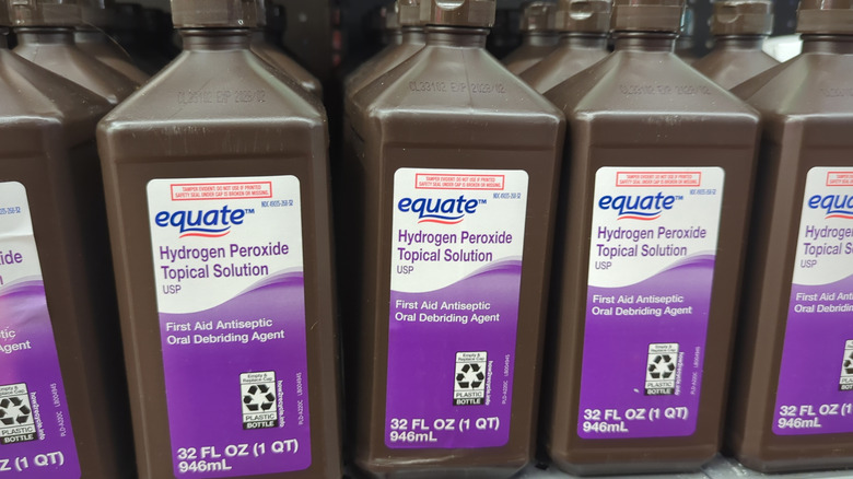 Bottles of hydrogen peroxide on a shelf in a store.