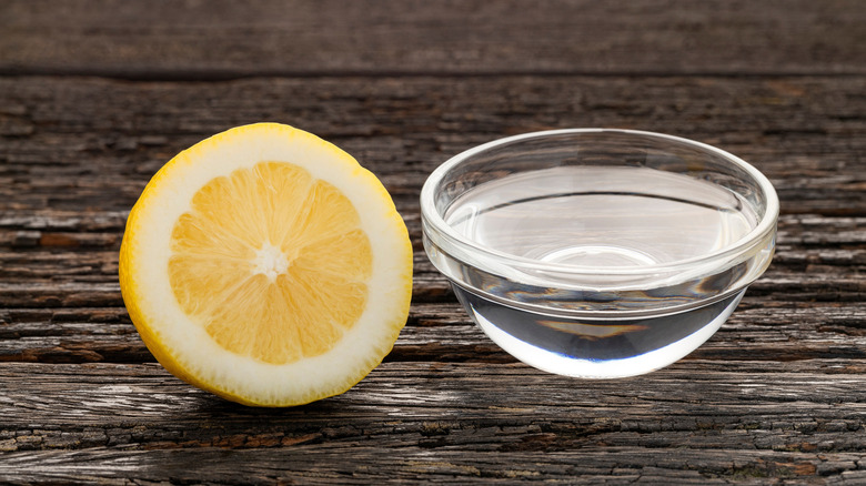 Lemon juice next to a bowl of water