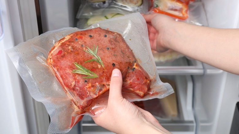 person holding sealed steak bag