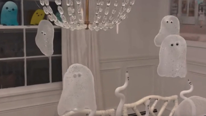 DIY ghost decorations around a chandelier
