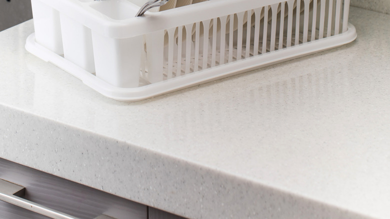 Dishes in traditional white drying rack on countertop