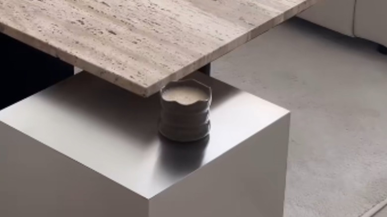 Chrome cube sits under a coffee table
