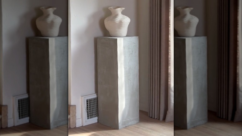 concrete column with a vase on top