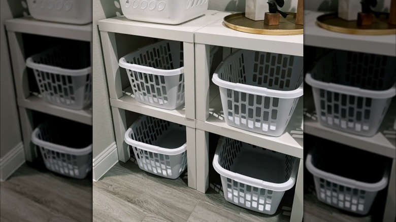 Stacked LACK tables with laundry baskets under them