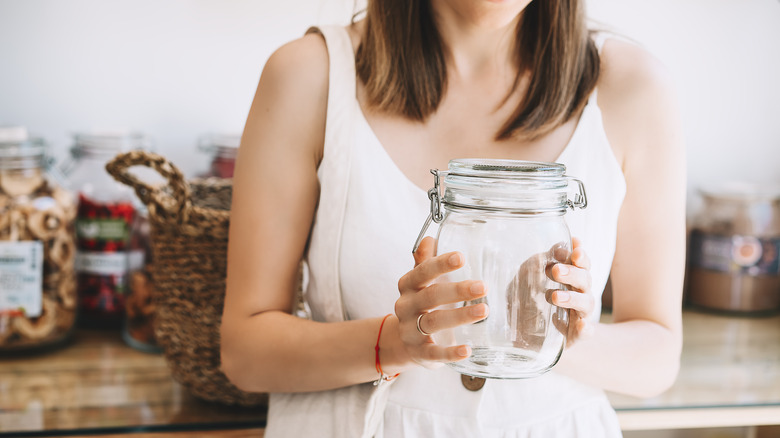 Woman holds clean candle jar