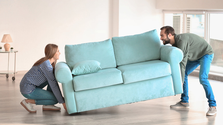 Couple moving a couch