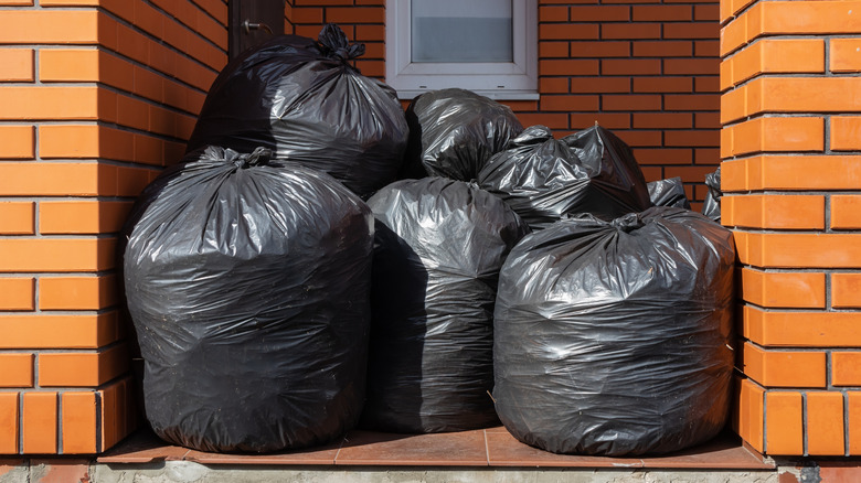 black tie trash bags outside brick buidling