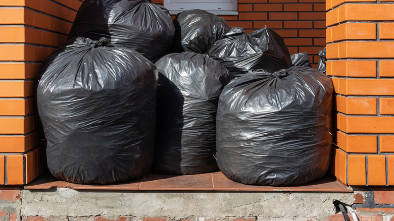 black tie trash bags outside brick buidling