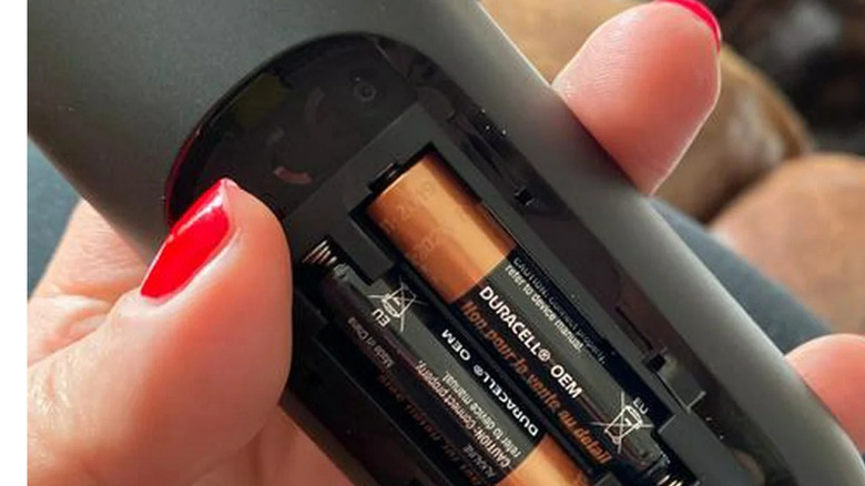 Duracell battery customer with AA Alkaline batteries in TV remote