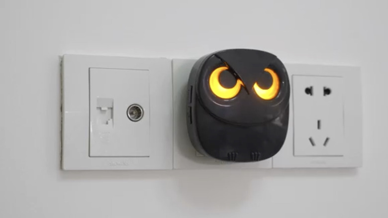 The HTZSAFE wireless alarm receiver plugged into an outlet and illuminated