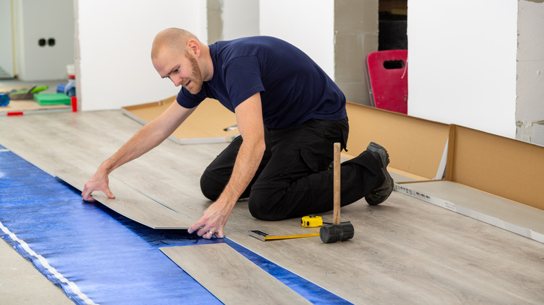 Man laying vinyl planks