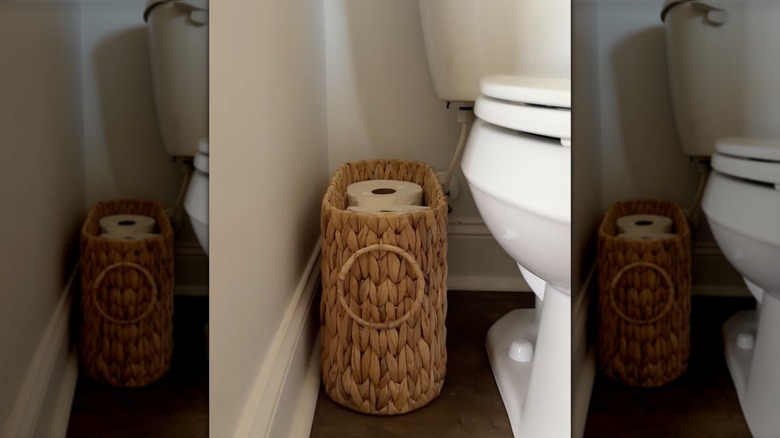 Amazon basket used for toilet paper storage next to the toilet.