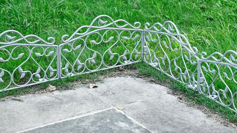 Plastic edging panels against the corner of a driveway