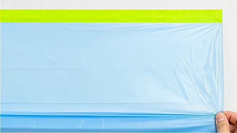 The Tangibay pre-taped masking film being unrolled on a flat surface