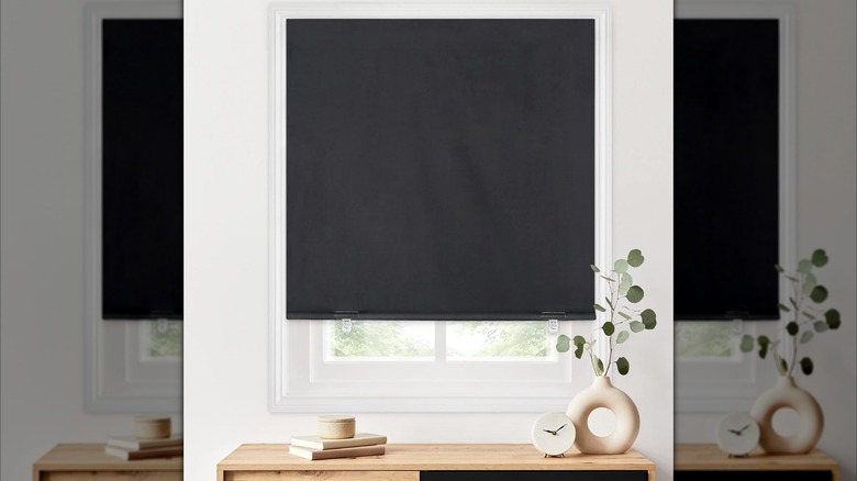 Image of Amazon blackout shades on a window with white walls and vase on a table