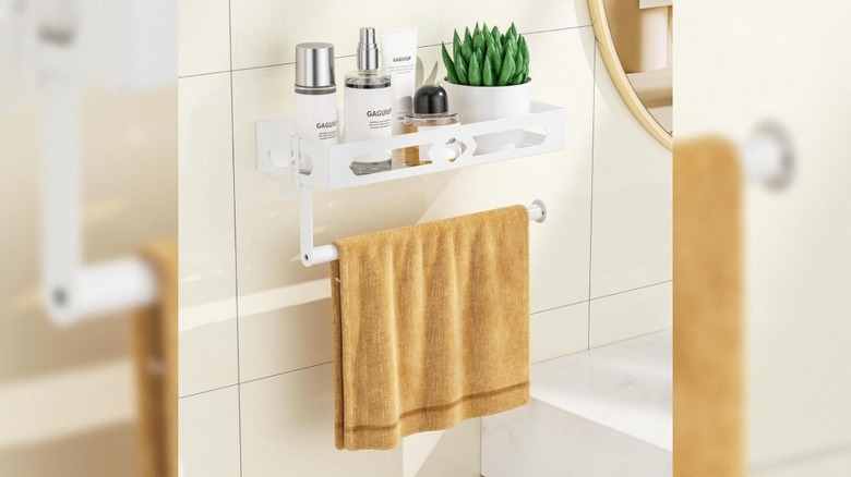 Yellow towel hanging on GAGUIUP White Paper Towel Holder Wall Mount with Shelf