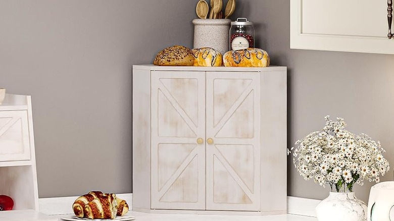 The Trironsun bread box closed on a counter topped with various baked goods and other items