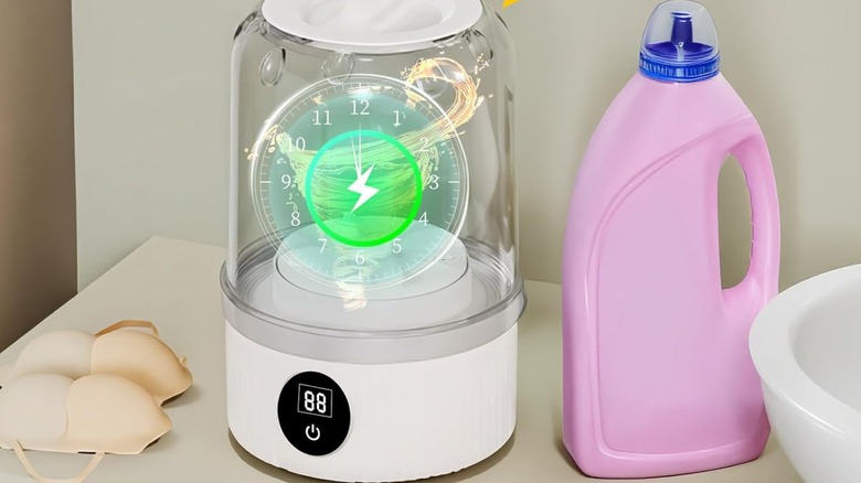 A portable washing machine near a detergent bottle