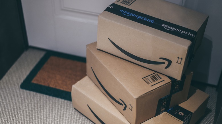 Pile of amazon delivery boxes on a doorstep