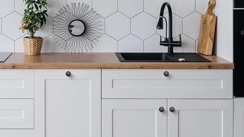 Black hardware of white kitchen cabinets