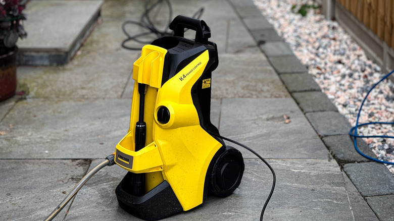 A black extension cord attached to a high-pressure washer