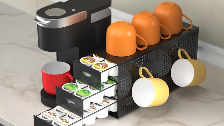 Amazon Keurig organizer with orange, yellow, and red cups on it and drawers filled with K-Cups