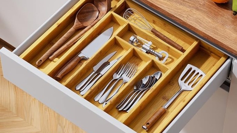 A cutlery organizer in an open kitchen drawer