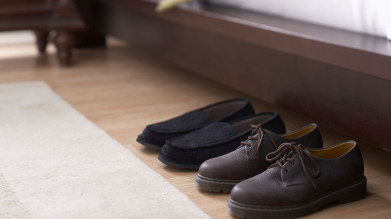 closeup of shoes beside bed