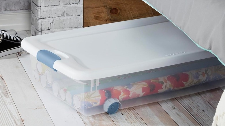 Sterilite container beside shoe under bed