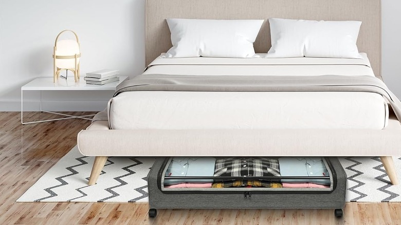 Yecaye's Under Bed Storage organizer with Wheels at the foot of a bed
