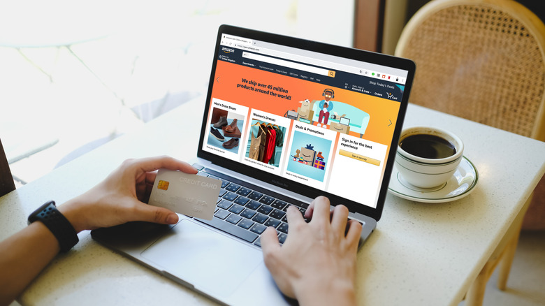 Person using credit card to shop on Amazon