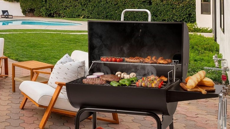 A Royal Gourmet charcoal grill with food cooking on it