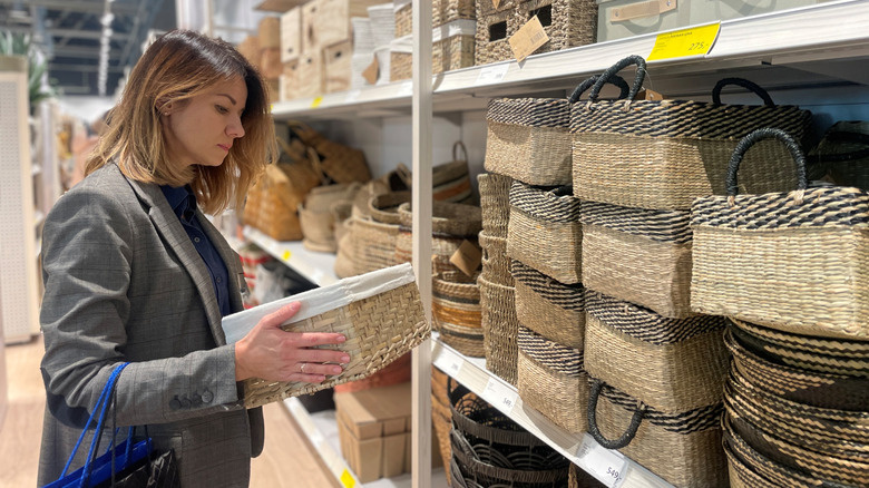 Woman shopping for woven baskets at a store