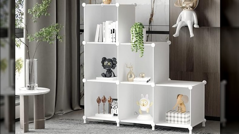 White six-cube organizer in home with various home decor items in each cube