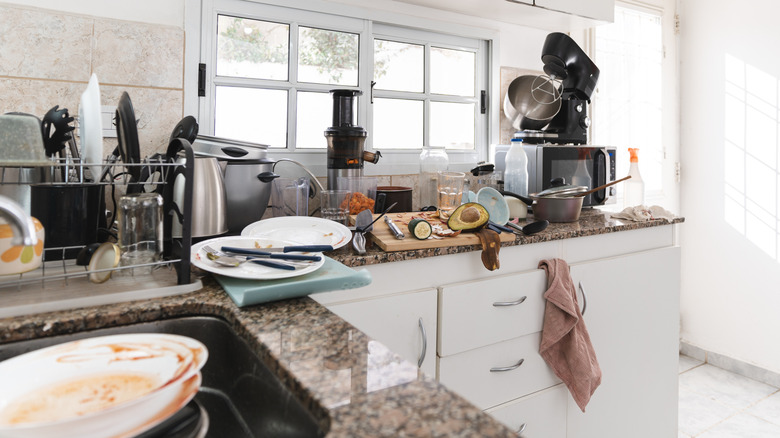 a modern kitchen with clutter on the counters