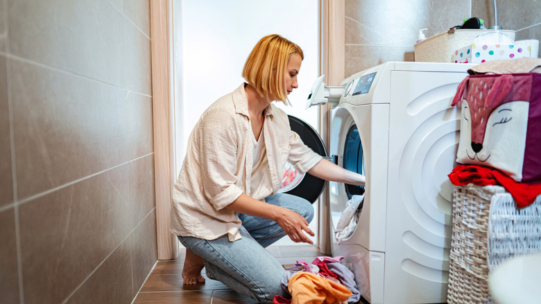 A woman doing laundry in a laundry room